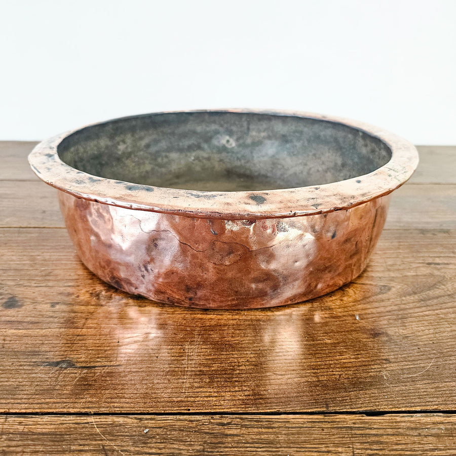 Small antique copper basin bowl with polished exterior.