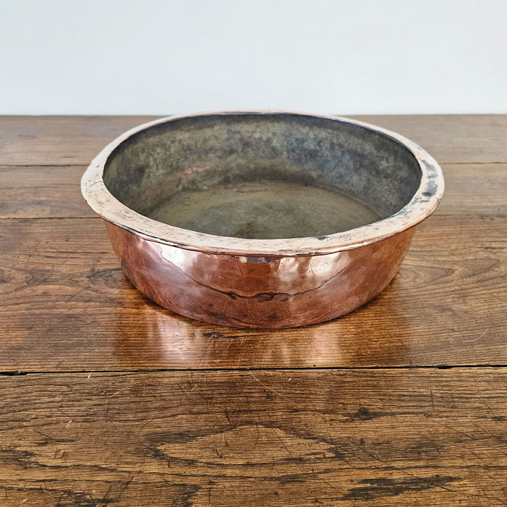 Rustic shallow copper bowl with original patination.
