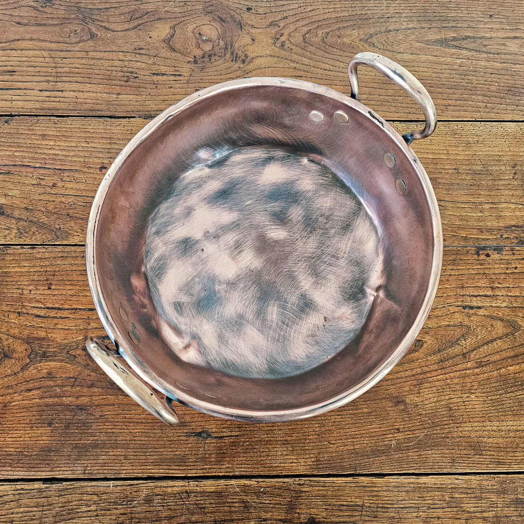 Vintage copper pan with twin brass handles.