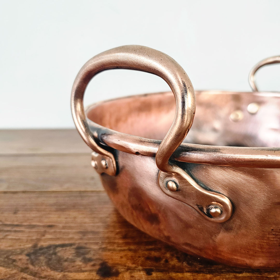 Victorian-era copper pan with polished exterior.