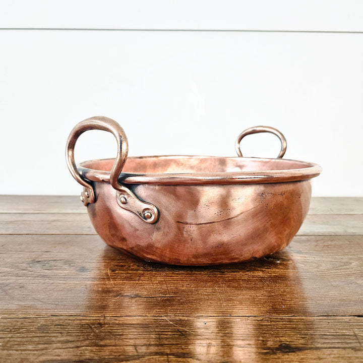 Vintage copper vessel with polished exterior.