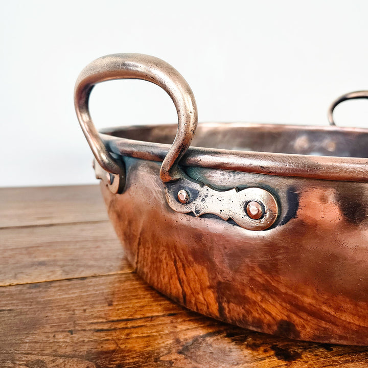 Vintage copper kitchenware, heavy-duty construction, timeless appeal.