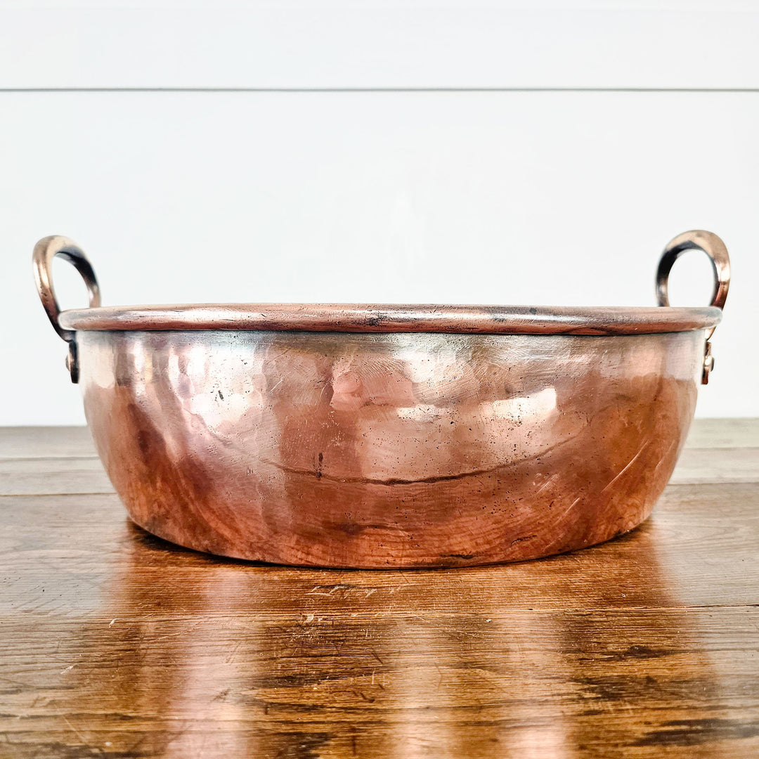 Antique copper pot, elegant addition to any kitchen collection.
