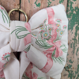 Large handmade bow crafted from original Sanderson “Daisy Stripe” vintage fabric dating to 1986. Lightly padded and structured for shape, with long flowing tails and a brass hanging hoop, a cottage style bow made in limited numbers.