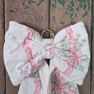 Handmade bow from the Country House range, produced from genuine vintage Sanderson “Daisy Stripe” fabric from 1986. Structured and padded with long tails and brass hanging hoop, a farmhouse style decorative fabric bow.