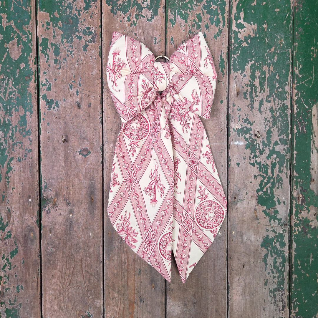 Handmade decorative bow from the Country House range, created in limited numbers using genuine vintage materials. Designed with a structured, padded body and brass hanging hoop, it adds a soft, elegant touch to farmhouse interiors, bedrooms, or dressing room doors.