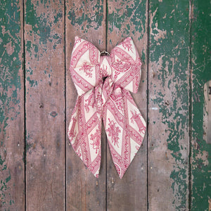 Country House Bow handmade from rare vintage fabric with a softly padded, shaped body and long tapering tails. Fitted with an antiqued brass hanging hoop, perfect for styling on doors, mantels, or shelves within country interiors.
