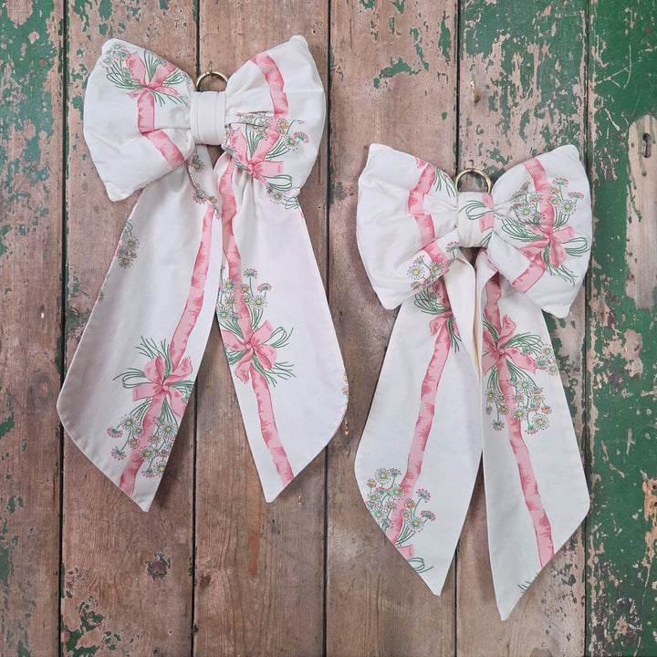 Handmade decorative fabric bow made using authentic vintage 1986 Sanderson “Daisy Stripe” cotton. Structured and padded for fullness with long tails and an antiqued brass hoop, a large cottage style bow with distinctive English vintage character.