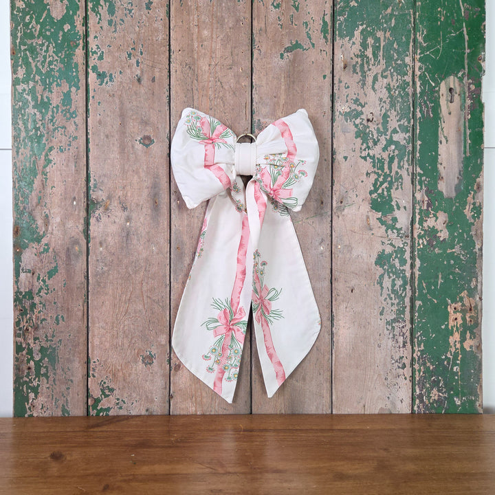 Handmade fabric bow from the Country House collection using vintage 1986 Sanderson “Daisy Stripe” material. Structured with padding for shape and long flowing tails, a farmhouse style large bow made from genuine vintage cloth.