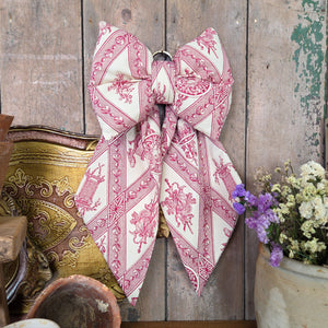 Decorative handmade bow from the Country House collection, crafted in Shropshire using unique vintage fabric. Lightly padded and shaped with tapered tails, each bow includes a brass hoop for hanging — a thoughtful, limited-edition accent for country homes.