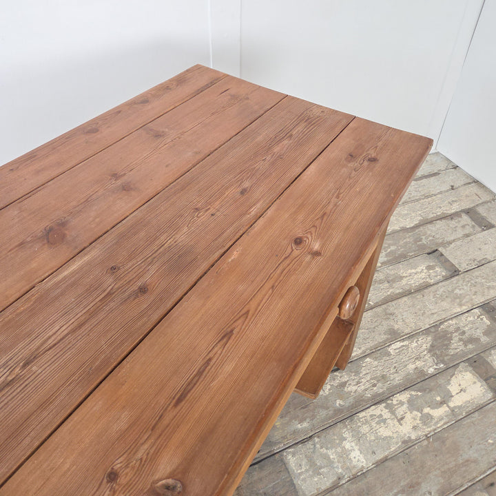 A 19th century Victorian pine farmhouse console table with planked top, two drawers and lower shelf. This antique pine piece was originally used as a prep table in large kitchens and now offers versatility as a rustic serving table, dining room sideboard, or hallway console. Raised on chunky straight legs, it is a practical and authentic example of Victorian pine furniture suited to both farmhouse and modern settings.