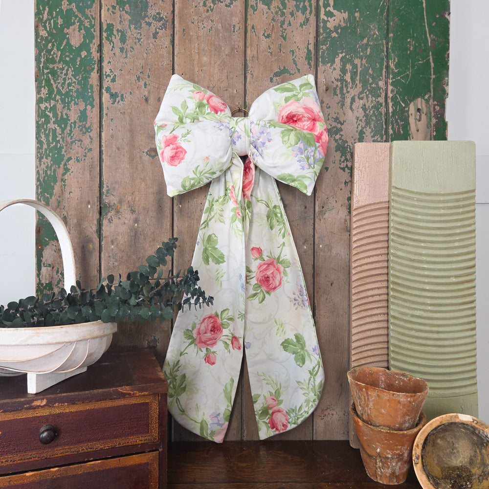 Handmade bow from Jennings & Cox crafted in vintage Sanderson Roses & Lilacs fabric. The padded body and tapering tails are complemented by a brass hanging ring, with only three created in this pattern, making each one a rare decorative accent.