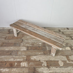 An early 20th-century country pine bench with a three-plank top and straight legs with circular lower stretchers. Well suited to a hallway or boot room, it can also be used at the foot of a bed or as a farmhouse dining bench.