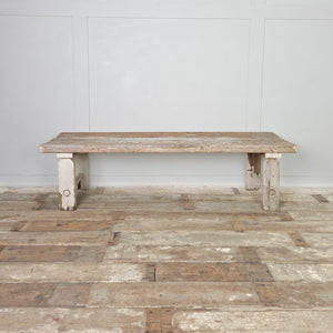 An early 20th-century antique country pine bench constructed with a three-plank top and straight legs connected by circular lower stretchers. Suitable for a hallway or boot room, it can also be used at the foot of a bed or as a dining bench.