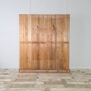 A farmhouse style pine cupboard dating from the early 20th century, with glazed doors opening to reveal adjustable internal shelving. Finished with a waxed finish, this large antique cupboard is perfect for storing household items and is full of country charm.