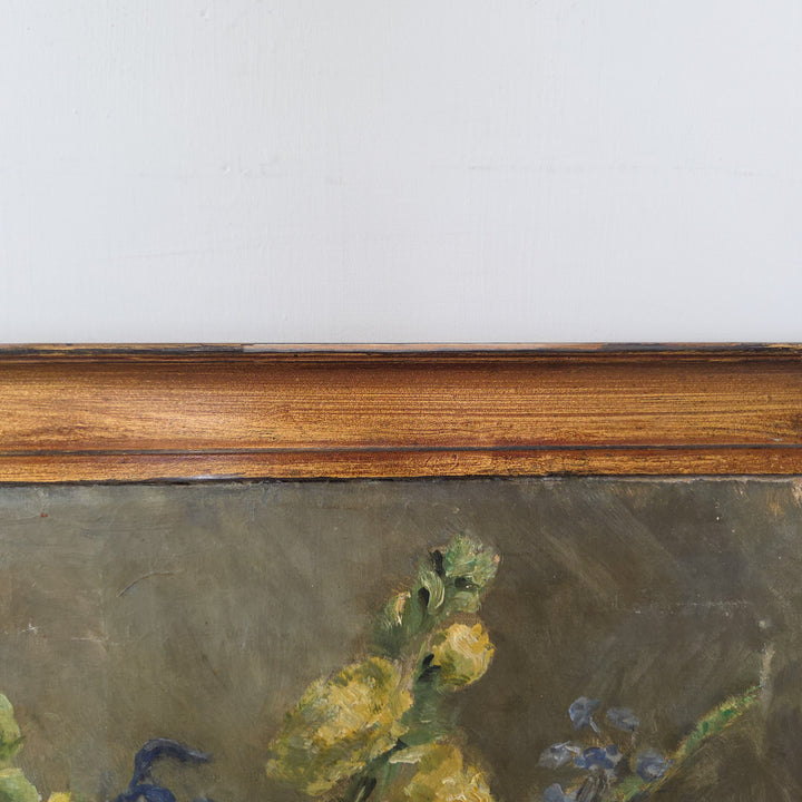 A signed and dated 1929 floral oil painting by L Graham Smith, presenting a collection of garden flowers in a soft impressionist style. Set within a painted gilt frame, this piece is a classic example of early 20th-century floral art.
