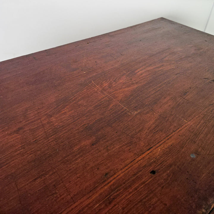 An early 20th-century dark stained pine chest with four drawers, each with brass cup handles. Built from solid pine with a moulded top, plinth base, and panelled sides, the chest displays the honest, functional design associated with country-made antique furniture.