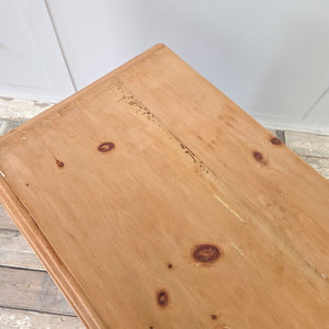 Antique pine chest of drawers from the early 20th century with four drawers in a two over two layout. Retains original brass swan neck handles and escutcheons. The chest has a warm pine patina, sits on a plinth base with decorative cut-out, and is finished with moulded edges to the top for a clean look.
