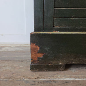 A four drawer antique painted chest of drawers dating from the early 20th century. The piece features a deep green painted finish with hand-painted decoration throughout, including a ship motif to the top and lettering to the drawers. Raised on a plinth base and suitable for bedroom drawers or living room storage.