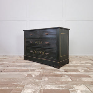 A characterful antique painted chest of drawers dating from the early 20th century. Finished in deep green paint with hand-painted decoration throughout, including a ship motif to the top and lettering to the drawer fronts. Built in mahogany veneer and suitable for use as bedroom storage.