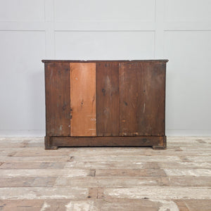 An early 20th century painted mahogany-veneered chest of drawers with four drawers and decorative hand-painted details. The dark green painted finish includes lined borders, lettering to the drawers, and a painted ship scene to the top. Suitable for bedroom storage or use as a sideboard.