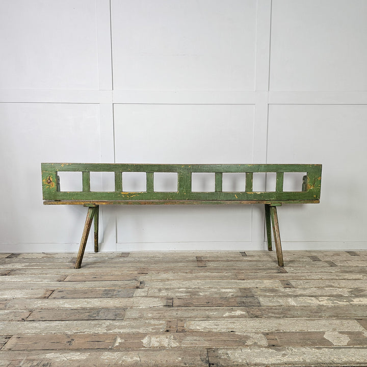 Pine stick bench with pivoting backrest and narrow form
