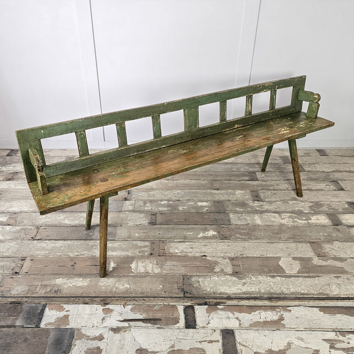 Painted pine bench with slatted back and pegged joints
