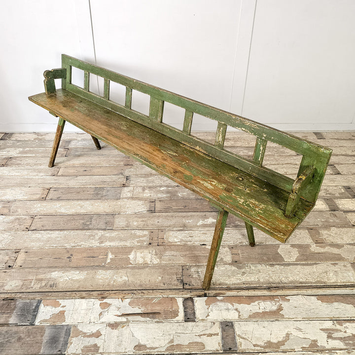 Antique flip bench with splayed legs and hinged backrest
