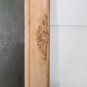 A vintage 20th century floral still life oil painting signed by British artist Thomas Bradley, depicting a decorative vase filled with radiant flowers in blushing pinks and sunny yellows, set against a dark background and framed within a complementary painted wooden frame for displ