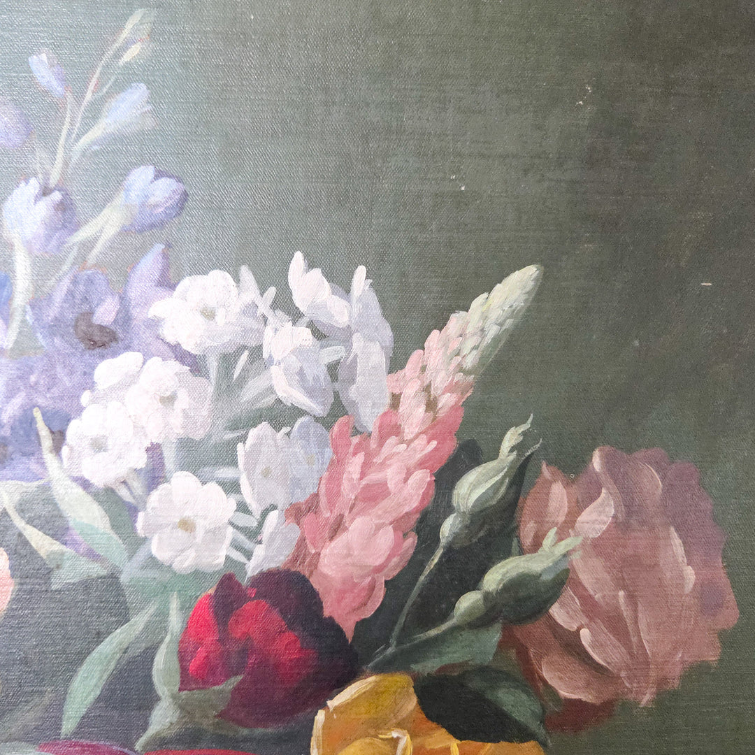 Mid 20th century floral oil painting signed by Thomas Bradley, showing a vase of flowers in shades of pink and yellow contrasted against a dark ground. The still life composition is painted on board and set within a decorative painted frame, highlighting its traditional subject and style.