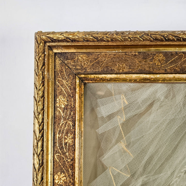 Wax flower crown and gathered veil in antique glass frame
