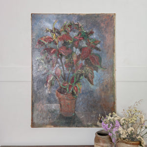 Early 20th century French oil painting on canvas depicting a terracotta pot with red and green foliage against a softly textured blue and grey background. The warm tones of the plant contrast with the muted background, creating a calm, rustic still life.