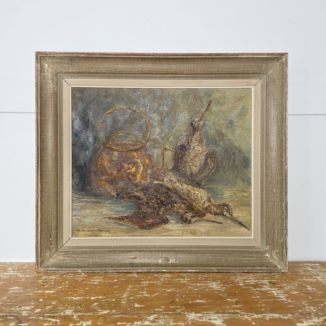 A 20th century vintage French still life oil painting signed by Marcelle Macqueron-Thompson. The artwork depicts a trio of game birds beside a copper kettle, painted with textured detail. Presented in a decorative wooden frame, this original piece is ready to hang.