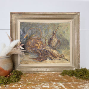 A framed 20th century French still life oil painting on canvas by Marcelle Macqueron-Thompson. The composition depicts three game birds beside a copper kettle against a neutral textured ground. Signed lower left, this original artwork is ready to hang within the home.