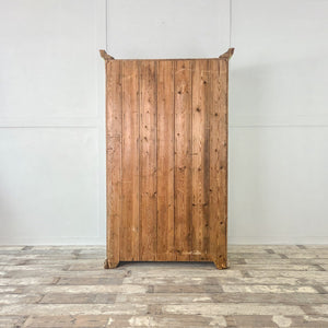 A rustic French painted cupboard from the early 20th century, finished in soft green and housing eight internal drawers behind two doors. The slatted bases and graduated depths point to former pantry use. The shaped plinth and cornice give this antique storage cupboard a cottage-style presence.