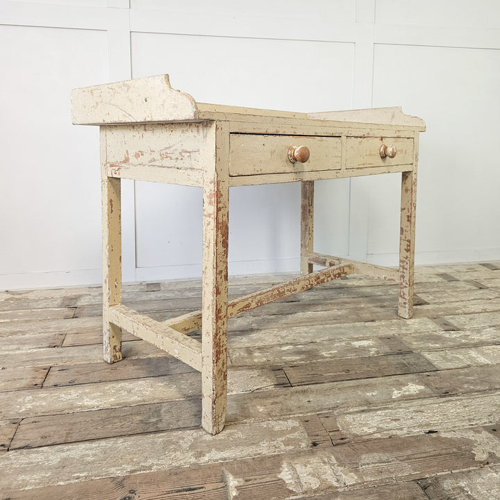 Antique table with gallery back and wooden knobs
