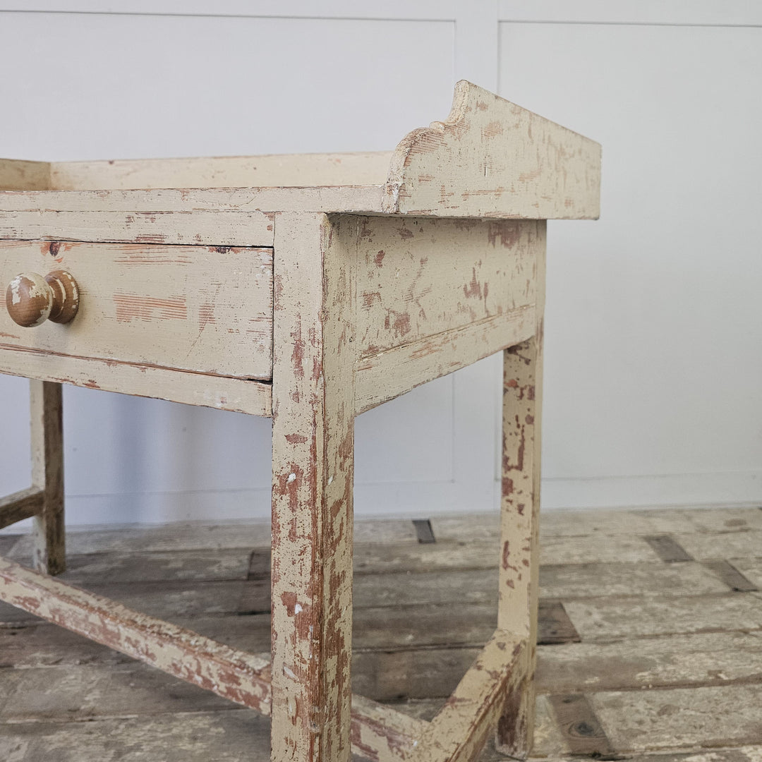Pine table with gallery and drawer storage
