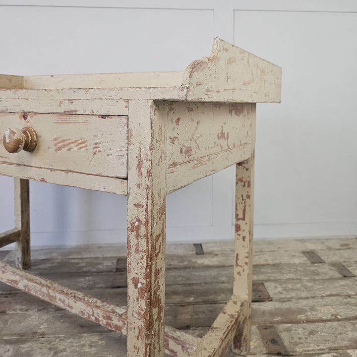 Pine table with gallery and drawer storage
