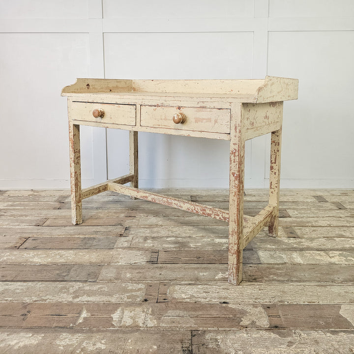 Antique French console table with distressed cream paint
