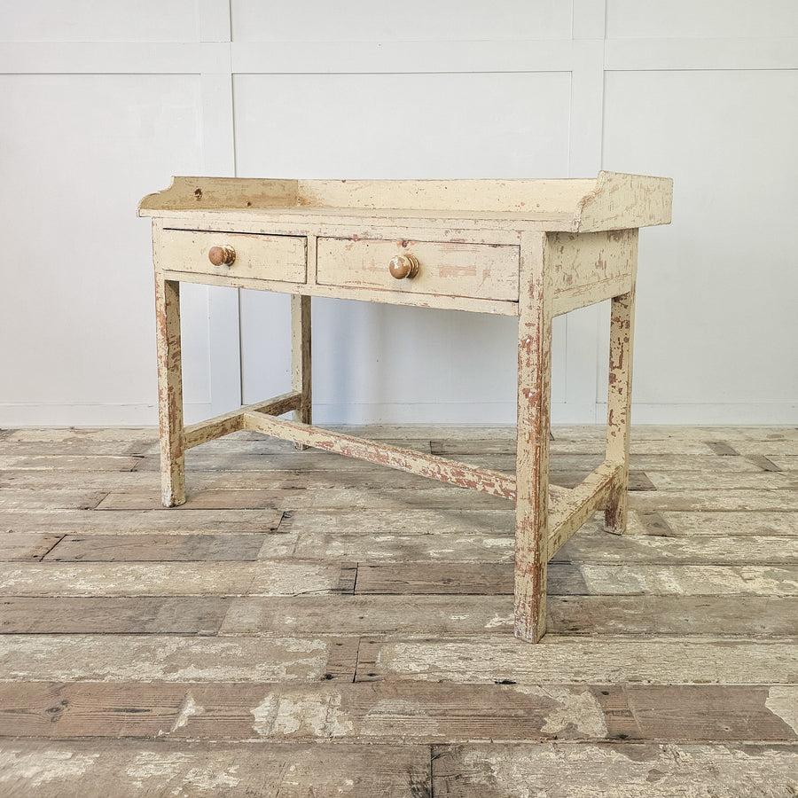 Antique French console table with distressed cream paint
