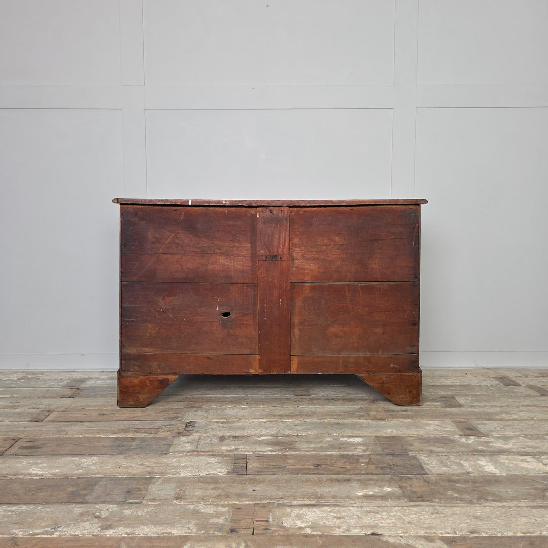 Antique oak chest of drawers from the Georgian period, early 19th century, featuring four drawers with brass fittings and decorative bracket feet. The oak finish has developed a lovely rich patina over time.