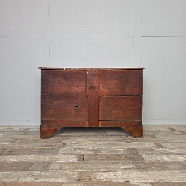 Antique oak chest of drawers from the Georgian period, early 19th century, featuring four drawers with brass fittings and decorative bracket feet. The oak finish has developed a lovely rich patina over time.