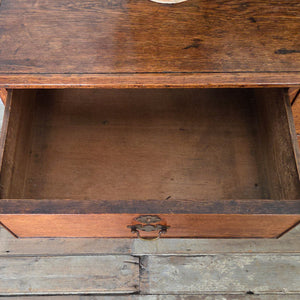 A fine early 19th century Georgian oak chest of drawers featuring four drawers, decorative bracket feet and its original brass swan-neck handles. The oak has developed a soft, even patina and subtle wear from age, adding character to this well-made antique piece.