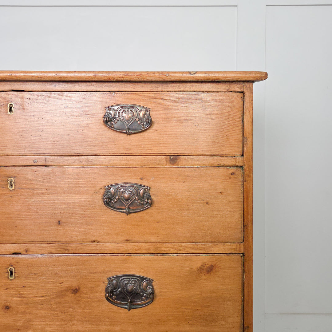 An antique Georgian pine chest of drawers dating to the early 1800s, with brass hardware and bracket feet. A well-proportioned piece of country pine furniture, demonstrating the enduring appeal of Georgian craftsmanship.