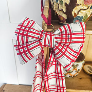Handmade bow with brass ring, suitable for festive décor.
