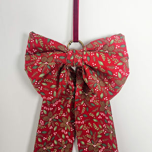 Brass-ringed bow with velvet ribbon, holiday themed

