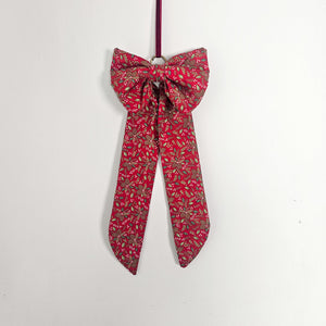 Handcrafted plush bow with decorative ribbon
