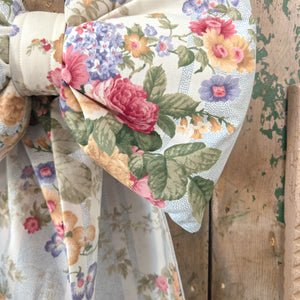 Handmade decorative bow from the Jennings & Cox Country House collection, created from vintage floral stripe fabric with a padded structure. Each bow is unique, finished with a brass hanging ring, and designed for versatile display in the home or at events.