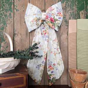 Handmade decorative Country House Bow created from vintage floral stripe fabric with a soft padded design and elongated tails. Finished with an antiqued brass hanging ring, this unique bow can be styled on doors, shelves, or used as a thoughtful gift for weddings and special occasions.