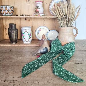 Handmade festive bow with brass ring and velvet ribbon.
